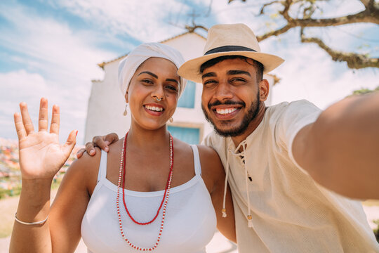 Tourist making a selfie with a Bahian woman. happy Brazilian woman dressed in the traditional Bahian costume of the Umbanda religion