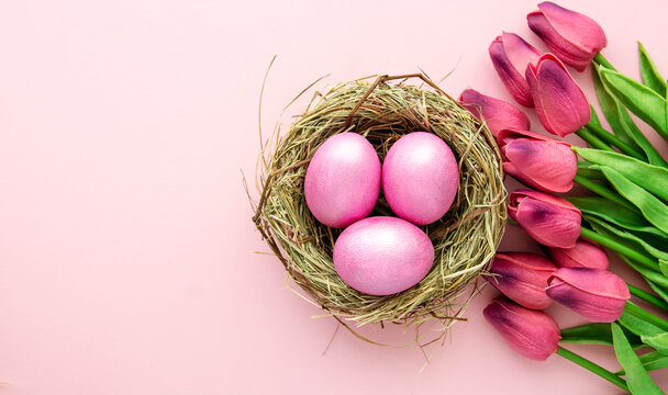 easter background with delicate color pink paint eggs on beige background 