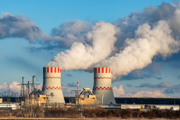 Nuclear power plant with Cooling tower with steam of Atomic power station. Industrial zone of...