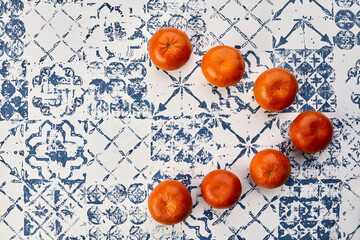 fresh tangerines on the kitchen table - 422647984