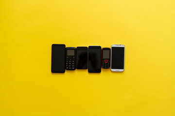 technology evolution concept, some old vintage phone cell phones and new nodern devices