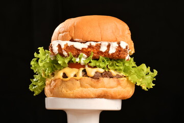 A hamburger (also burger for short) is a sandwich consisting of one or more cooked patties of ground meat, usually beef, placed inside a sliced bread roll or bun.
