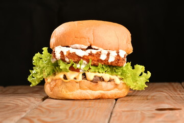 A hamburger (also burger for short) is a sandwich consisting of one or more cooked patties of ground meat, usually beef, placed inside a sliced bread roll or bun.
