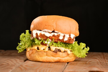 A hamburger (also burger for short) is a sandwich consisting of one or more cooked patties of ground meat, usually beef, placed inside a sliced bread roll or bun.
