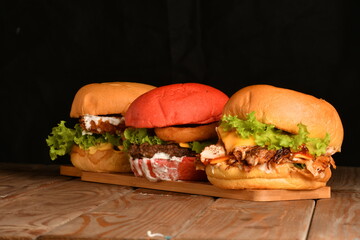 A hamburger (also burger for short) is a sandwich consisting of one or more cooked patties of ground meat, usually beef, placed inside a sliced bread roll or bun.
