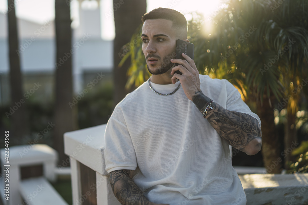 Poster handsome european man talking on the phone with a surprised face expression