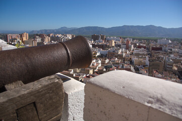 Fototapeta na wymiar Close-up of a cannon on the wall of the castle of Cullera