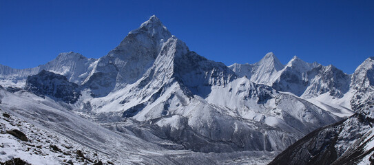 Clear blue sky over snow covered Mount Ama Dablam.