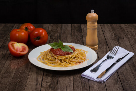 Bavette Pasta With Red Sauce. Red Tomatoes. Cutlery On Napkin. Front Photograph.