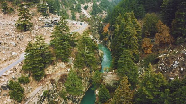  
Aerial View of bridge above the Bhagirathi river surrounded by green, Yellow pine forest in Harsil Valley of Uttarakhand, India.
