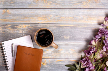 A Single Bible and Cup of Coffee on a Distressed Wooden Table