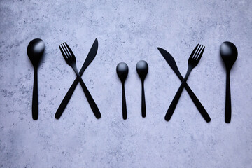 black cutlery on a marble table - 422652355