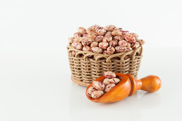 Pinto beans, a legume native to the American continent; photo on white background.