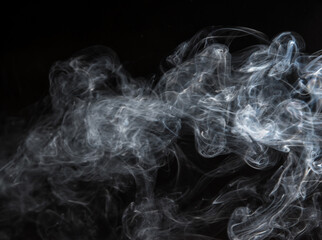 Abstract puffs of smoke on a black background.