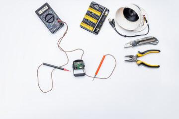 cctv camera service repair concept. above view. adjusting surveillance camera using tools on white desk