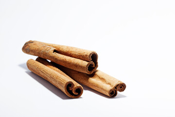 cinnamon sticks lying on white background