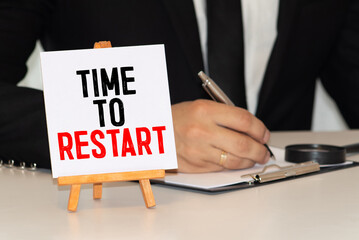 businesswoman holding a black paper plate with text TIME TO RESTART