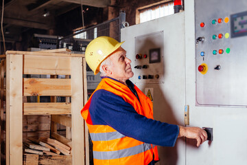 the senior man in uniform is working at the factory