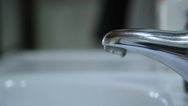 Tap Water dripping wastage,falling potable water drop,pure water conservation