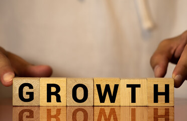 Wooden blocks arranged in stair shape with word growth for career, financial, economy or investment growth conceptual
