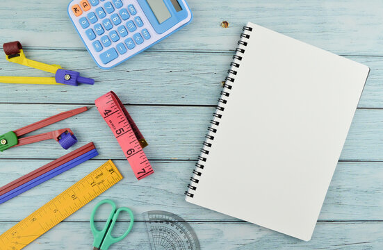 Stationery tools and notebook with copy space over wooden background