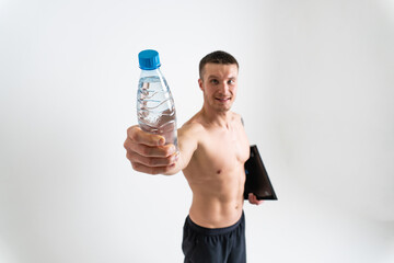 Male drink-water fitness is pumped with a towel on a white background isolated fitness athlete lifestyle, drink healthy sportswear bottle person, muscles athletic. Towel protein active, thirsty one