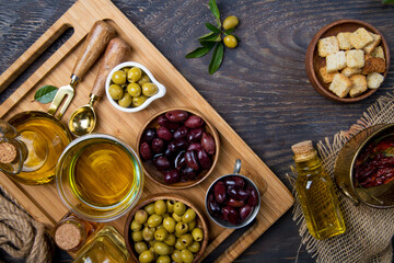 Olive oil and green olives shot from above