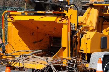 Wood chipper machine releasing the shredded woods into a truck