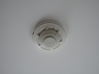smoke detector fire alarm head on the ceiling in office.
