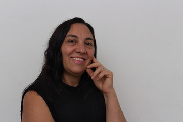 Fototapeta na wymiar Black haired woman and black dress on white background smiling