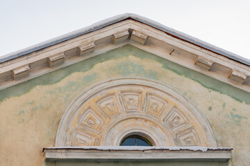 Dormer window with bas-relief. Old house in the center of Magnitogorsk.