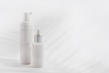 Foam container and bottle with serum on light background. Cloud dancer