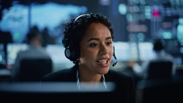 Portrait of Professional IT Technical Support Female Specialist Working on Computer in Monitoring Control Room with Digital Screens