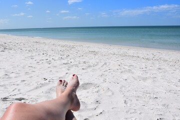 Legs crossed relaxing on the beach 