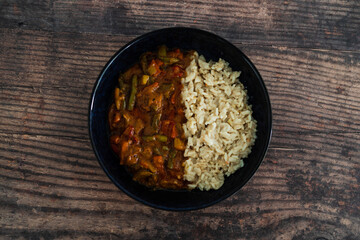 vegan stir fry with peanut sauce and coconut milk rice, healthy plant-based food