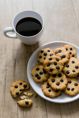 Cup of black coffee and low carb Keto Diet cookies on wooden table. Concept healthy eating food. Top view