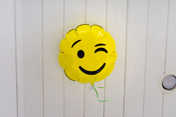 happy winking balloon on the ceiling