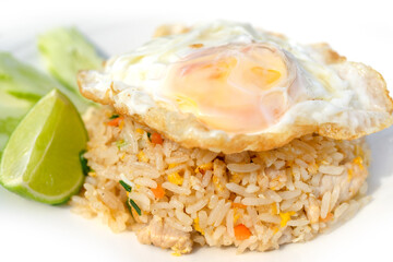 Fried rice with pork or chicken and vegetables topping with fried eggs