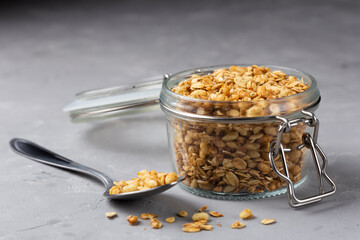 Glass jar with granola on the table.