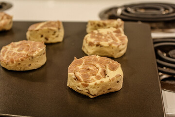 Delicious uncooked cinnamon roll on a pan waiting to be cooked