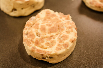 Delicious uncooked cinnamon roll on a pan waiting to be cooked
