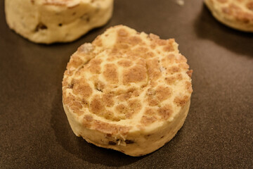 Delicious uncooked cinnamon roll on a pan waiting to be cooked