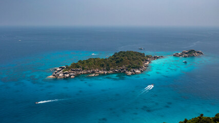 Fototapeta na wymiar Aerial drone view of boats around the tree covered island of Ko Similan in Thailand 2021
