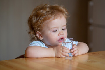 Healthy nutrition for kids. Baby drink water. Portrait of a sweet Beautiful child drinking a glass of water.