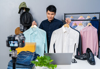 man selling clothes and accessories online by camera live streaming, business online e-commerce at home