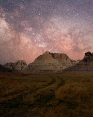 Fototapeta na wymiar An amazing view of the Milky Way above desert sand formations, Badlands National Park. An awe night sky view with our galaxy. An idyllic and motivational scenery.