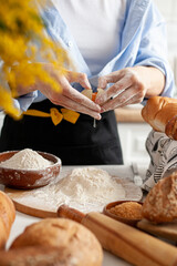 baker kneading dough on the table