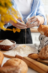baker kneading dough on table