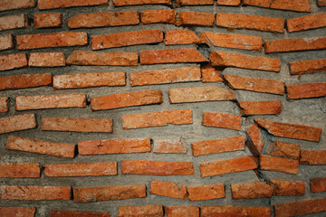 Close up of Cracked brick wall, Cracked brick wall background. Red brick wall texture.