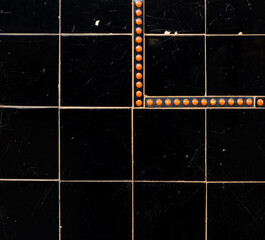 black tiles with orange spot detail